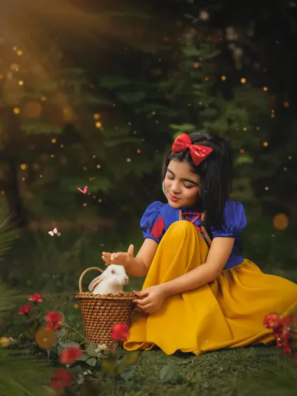 In a magical forest clearing, our Snow White gently pets a soft white bunny. I love incorporating live animals safely into shoots to bring an extra layer of wonder and authenticity.