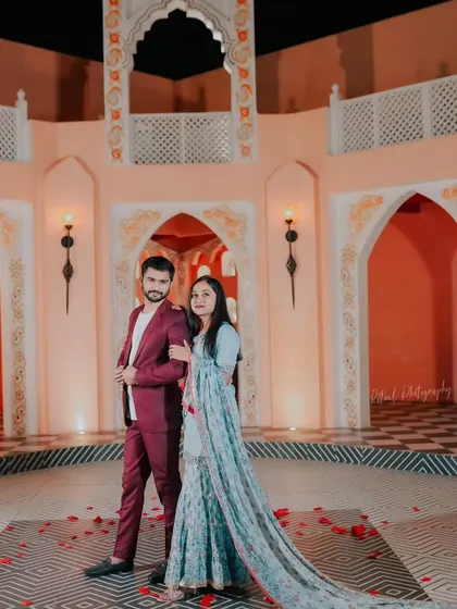 A grand portrait in a stunning courtyard. The bride's flowing traditional outfit and the elegant architecture come together to create a picture of timeless grace.