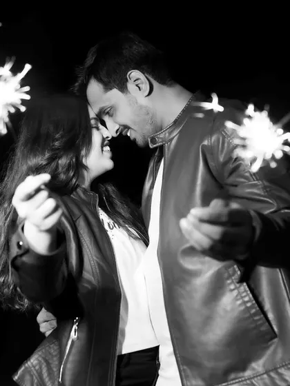 A classic and joyful black and white shot using sparklers to light up the night. This image captures the fun and celebration of getting engaged, creating a timeless memory of the couple's happiness.