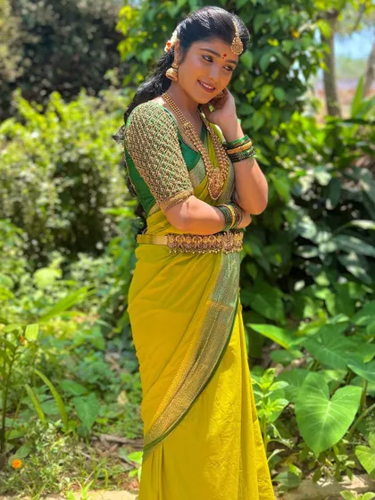 The rich green of the embroidered blouse stands out beautifully.