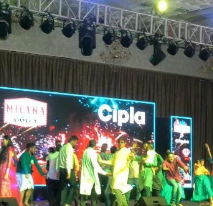 The stage setup for the Cipla family day, showing the large LED screens and professional lighting rig.