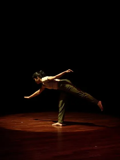 A dancer balances gracefully in a contemporary piece from the Parabola of Dance series.