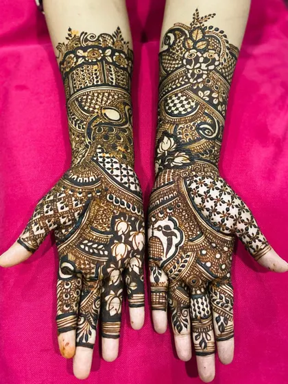 The beauty of traditional henna lies in the details. Here you can see the combination of bold figures and fine line work that makes the design stand out.