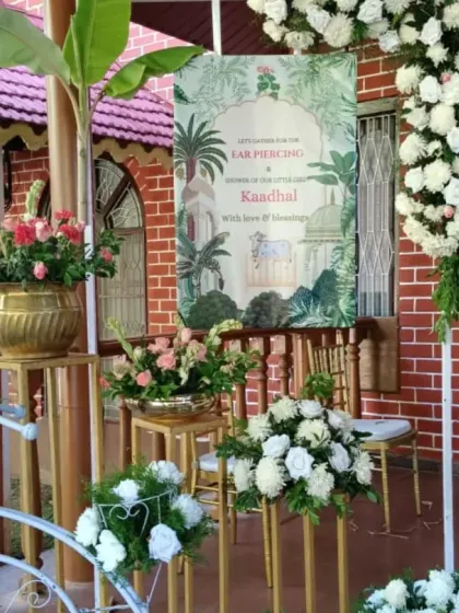 The entrance decor for an ear piercing and tonsure ceremony. A custom welcome board and a bicycle decorated with flowers create a charming first impression for guests.