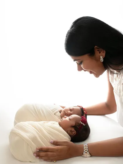 A mother looking down at her sleeping twins. The simplicity of the white background keeps all the focus on her love and their peacefulness.