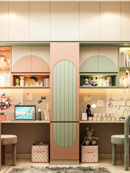 We designed this dual study station for siblings to share. The symmetrical layout features pastel pink and green cabinetry, providing each child with their own personalized desk space, shelving, and storage.
