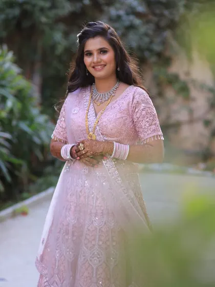 A beautiful smile to go with a beautiful lehenga. This client looks radiant in a pink embroidered lehenga, perfect for her engagement ceremony.