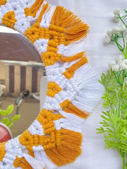 A close-up of the knotting on our yellow and white boho mirror. We use tight, consistent knots to ensure every piece is durable and beautifully finished.