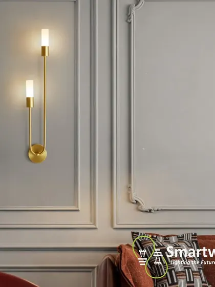 A beautiful U-shaped wall sconce with a gold finish, adding a touch of art-deco elegance to a classic interior.