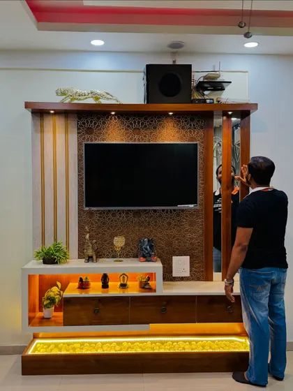 This TV unit includes a hidden storage panel on the side, a clever way to keep things tidy and out of sight.