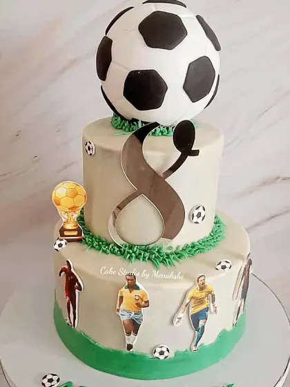 A stunning football themed cake made with zero fondant. This two-tier design features a 3D football on top and images of famous players.