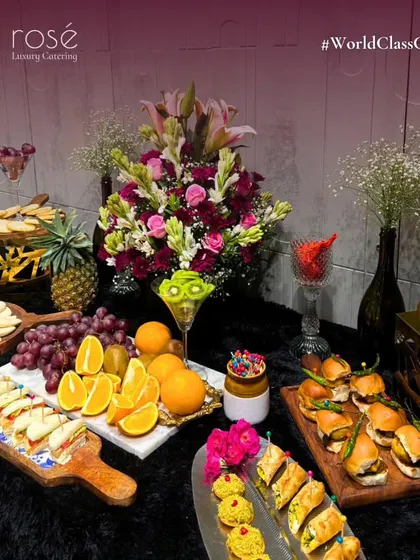 Another view of our abundant grazing table, showcasing a variety of appetizers like mini sandwiches and sliders. We can create these lavish spreads for both intimate affairs and large-scale galas.
