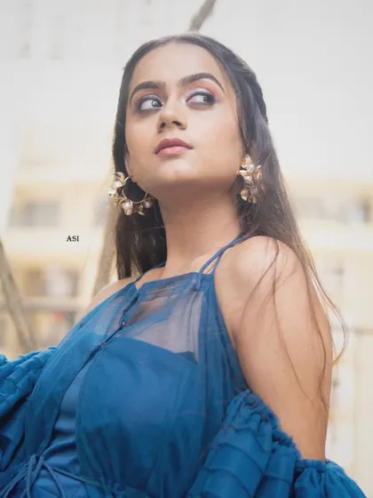 A close-up portrait from a photoshoot featuring a dramatic blue tulle gown. These collaborations with photographers and makeup artists help bring my collection to life.