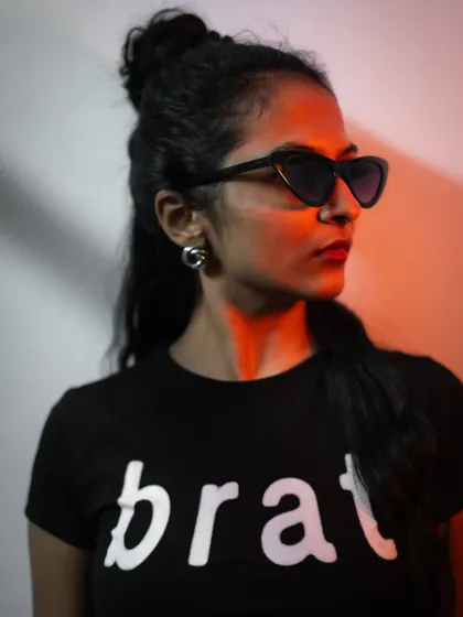 A side profile portrait with dramatic lighting. The contrast of the warm light on my face and the dark background creates a striking, high-fashion image.