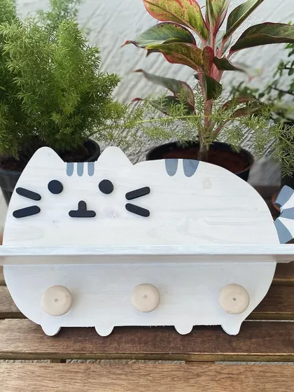 Purr-fect for your furry friend! This cat-shaped shelf with hooks is designed to organize your pet's leashes, toys, and treats, while also being a super cute piece of wall decor for any cat lover.