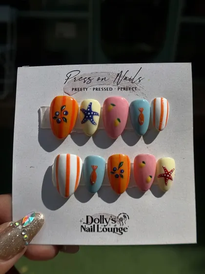 A fun, summery press-on set with a beach theme, including hand-painted starfish, fish, and colorful stripes.