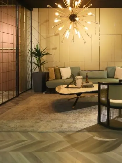 Another view of the contemporary lounge, showing how the pastel-hued wall panelling seamlessly integrates with the metal and glass sliding doors. This creates a cohesive and thoughtfully designed interior space.