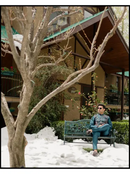 A portrait of the groom, looking thoughtful and serene amidst the snow, before the Mehendi festivities begin.