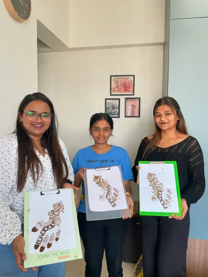 Happy students after a demo class. They are holding up their practice sheets showing an Arabic style design, a key part of the beginner's curriculum.