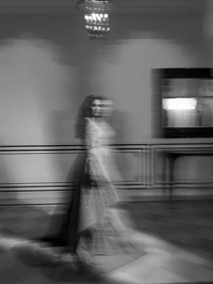 An artistic, motion-blur portrait of the bride from her reception, captured in black and white to create a dreamy, ethereal effect.