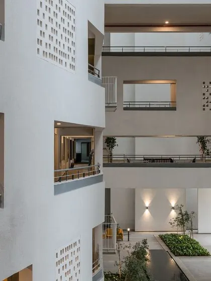 A view across the atrium, showing how different levels overlook the central landscaped court and water feature. This visual transparency is key to our community-centric design philosophy.