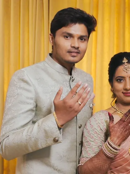 A happy engagement portrait of the couple showing off their new rings.