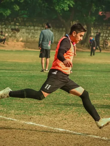 A player leaps to control a high ball.
