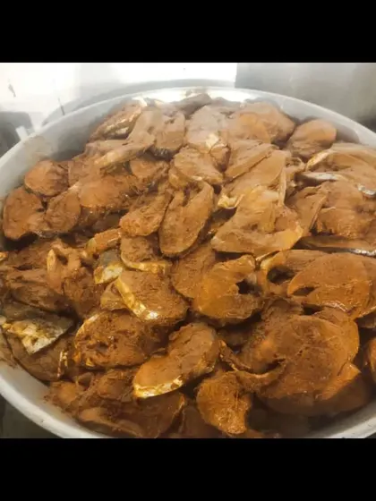 Fish steaks marinating in a thick layer of spices. This ensures the flavor goes deep into the fish.