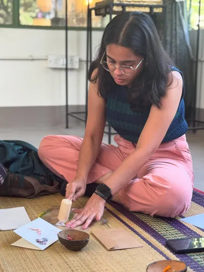 Deep in the creative zone, this participant is carefully pounding her floral design. The process requires a gentle touch and patience, making it a very mindful and relaxing art form.