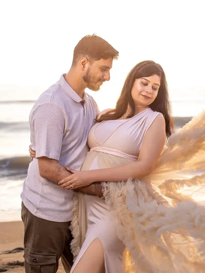 A gentle moment of connection. The soft light and serene expressions make this a truly timeless and romantic beach portrait.