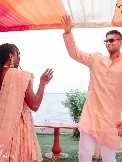 A candid moment of dance and joy at Nahdia and Varun's Mehendi party by the beautiful Kerala backwaters. The simple, colorful decor allowed the happiness of the guests to be the main focus.