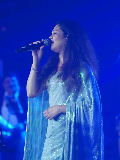 Priyanka Barve performing on stage in the glittering silver saree.