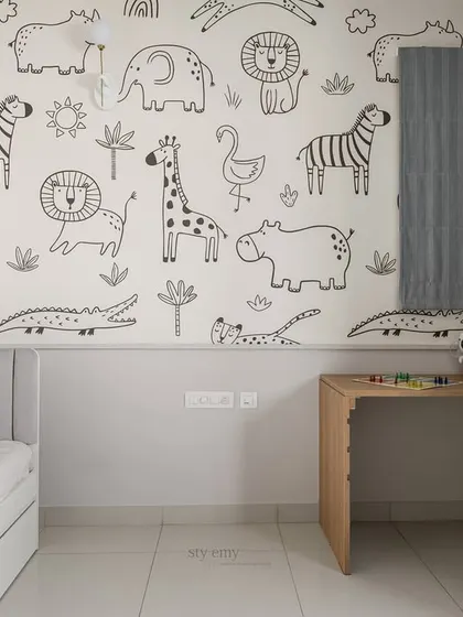 The adjustable study desk next to the animal-themed wallpaper ensures the space is functional for homework and creative projects, and can be adapted as the child grows.