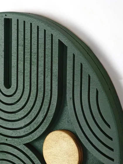 A close-up detail of the Radiant Sunburst art, showing the texture of the carved lines and the metallic sheen of the golden circles.