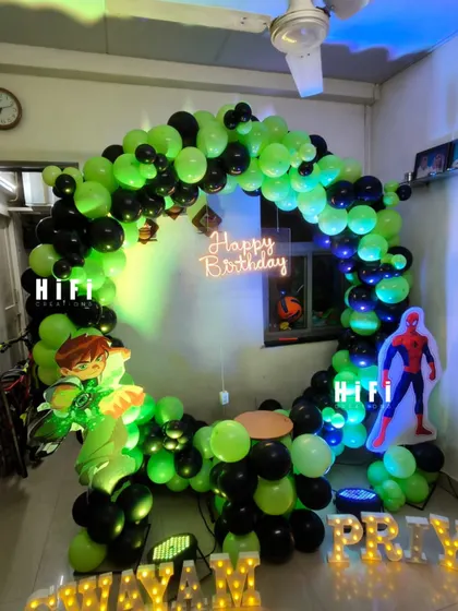 Your child's favorite heroes can make an appearance at their party. This action-packed birthday setup combines the worlds of Ben 10 and Spiderman with a custom balloon arch, character cutouts, and marquee letters, all designed to fit perfectly in a home setting.