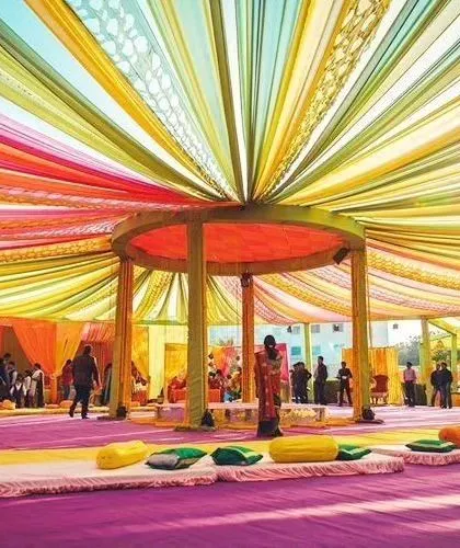 A massive tent setup with a canopy of colorful drapes radiating from the center. This kind of large-scale decoration is perfect for big gatherings.