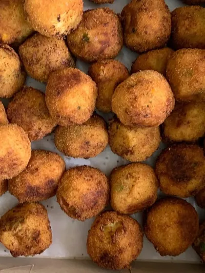 A box full of my popular Corn & Cheese Balls, fried to golden perfection.
