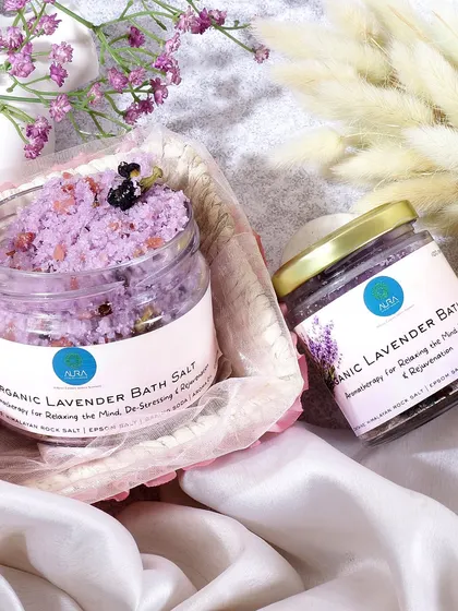 A delicate and soothing image of organic lavender bath salts. The soft fabrics, gentle lighting, and hints of purple flowers create a serene, spa like atmosphere, emphasizing the product's relaxing properties.
