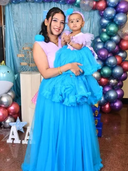 Another shot of the mother and daughter in their coordinated party outfits.