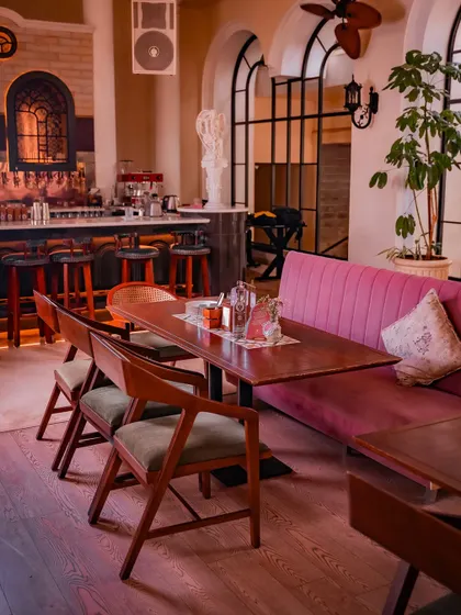This nook shows how different seating arrangements can create distinct zones within the mansion. A long table for a group dinner sits beside a cozy booth, offering flexibility for your event's needs.