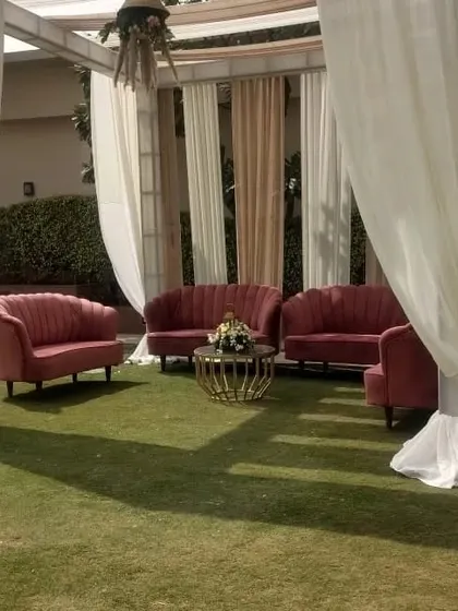 Another angle of the pink velvet lounge sofas, showing how they can be arranged under a draped canopy to create a semi private and intimate seating area for guests.