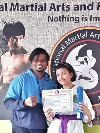 Another student earns her purple belt, a proud moment in her martial arts journey.