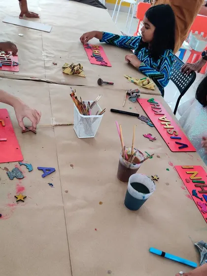 Kids are busy arranging letters and decorative elements on their nameplates. This activity is great for creativity and fine motor skills.