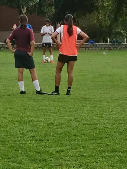Players in our girls' program listen to instructions before a drill. Team talks and strategy are a key part of every session.