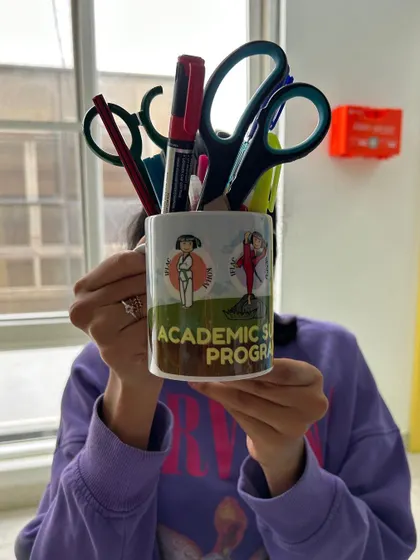 Our custom "Academic Support Program" mug, filled with stationery. Even our merchandise is designed to be fun and reinforce the IFLAC identity.