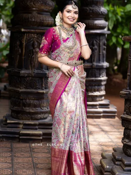 A gorgeous cream and magenta silk saree, perfect for a bride who wants a blend of subtle and vibrant tones. The silver zari work gives it a contemporary feel while remaining deeply traditional.