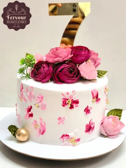 A floral cake for a 7th birthday, featuring hand-painted flowers and a topper. This exotic fruit cake is a great example of a non-fondant, elegant design.