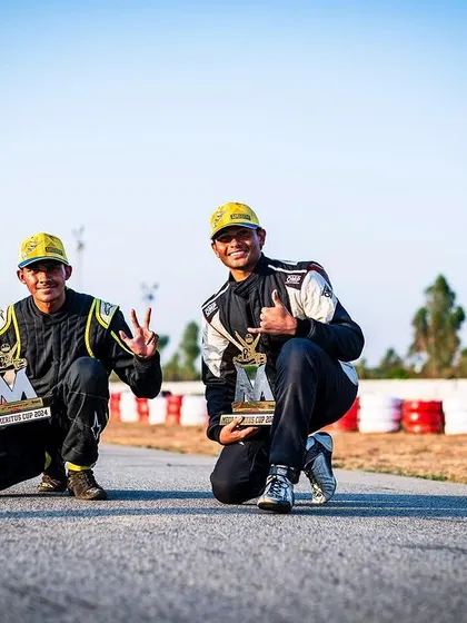 Two of our drivers posing with their trophies after a successful race weekend. Their smiles show the joy and satisfaction that comes from achieving their goals.