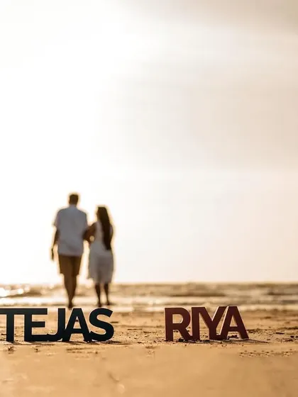 A creative shot using personalized name props, with the couple walking away into the sunset, symbolizing the start of their new journey.