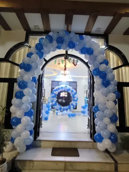 A straight-on shot of the grand entrance balloon arch in blue and white, perfect for welcoming a baby boy.